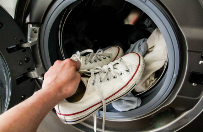 Putting sneakers into the washing machin