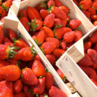 Fresh strawberries in wooden boxes, ready for sale