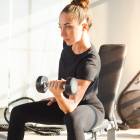 Woman doing weight lifting and increasing muscle mass