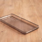Soft transparent mobile case in a light wood tabl